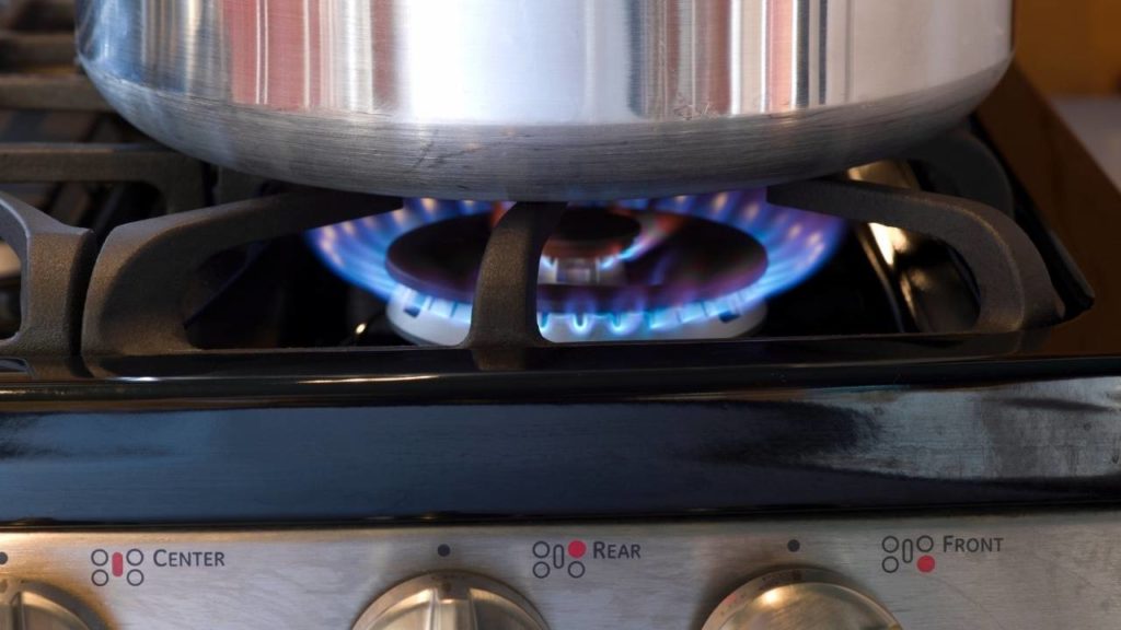heating aluminum bucket at gas flame